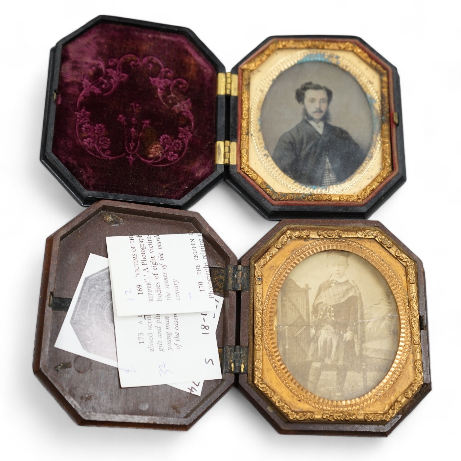 A pair of Peck & Co. sixth-plate ambrotype composite moulded cases, together with a Washington Monument phenolic cased ambrotype, largest 16 x 13cm. (3). Condition - fair